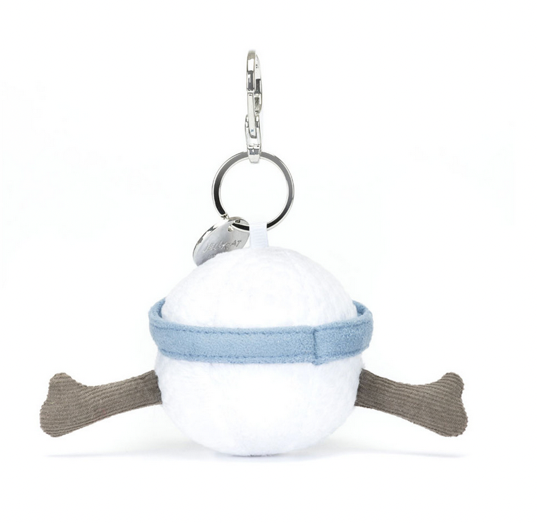 A round, plush keychain with a white ball body, blue band, and two protruding brown legs. Perfect as a golf bag charm or a thoughtful golf fan gift, it features a silver keyring and a small metal tag attached. This delightful accessory is the Jellycat Amuseables Sports Golf Bag Charm from Jellycat.