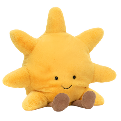A plush yellow Jellycat Amuseables Sun, Medium toy with eight rays, two black eyes, a small smiling mouth, and cheery cordy chocolate feet, sitting upright on a white background. This cuddly bundle brings warmth and joy to any room.