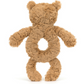 A fuzzy brown bear-shaped stuffed toy, crafted from recycled fibers, features a circular hollow in its torso and is shown displaying its back. The product is the Jellycat Bartholomew Bear Ring Rattle by Jellycat.