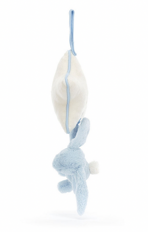 A **Jellycat Bashful Blue Bunny Musical Pull** with a white tail, reminiscent of the **Bashful Silver Bunny**, hangs upside down from a white object by a blue loop.