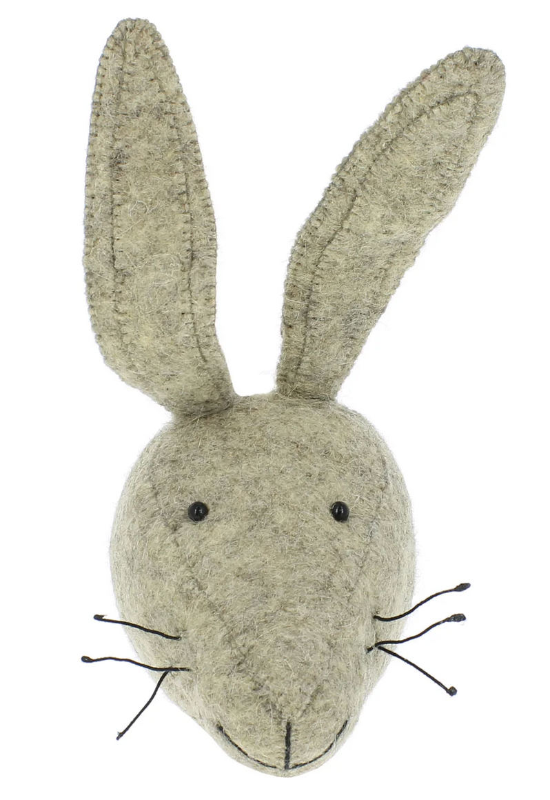 The Fiona Walker Hare Head Wall Decoration - Mini is a charming handcrafted piece featuring long ears and made from organic wool felt. Its stitched eyes, nose, and black whiskers add to its delightful appeal.