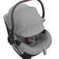 The UPPAbaby Aria Carseat by UPPAbaby is a grey infant car seat that features an extra-large canopy, a five-point harness, and a black base. It has a carrying handle with a brown grip and incorporates SmartSecure® technology for added safety.