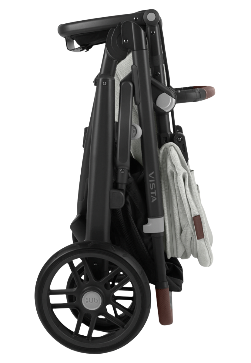 A folded black UPPAbaby Vista V2 Stroller with brown leather accents, featuring large wheels and a white cloth draped over the side. This versatile stroller from UPPAbaby offers multiple configurations, including a bassinet suitable from birth and a toddler seat that supports up to 50 lbs.