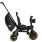 Side view of the DOONA Liki Trike - Midnight Edition by Doona, featuring a black and yellow color scheme with a black storage bag attached to the handlebar and a cup holder at the front. This compact folding trike design is an ideal stroller alternative.