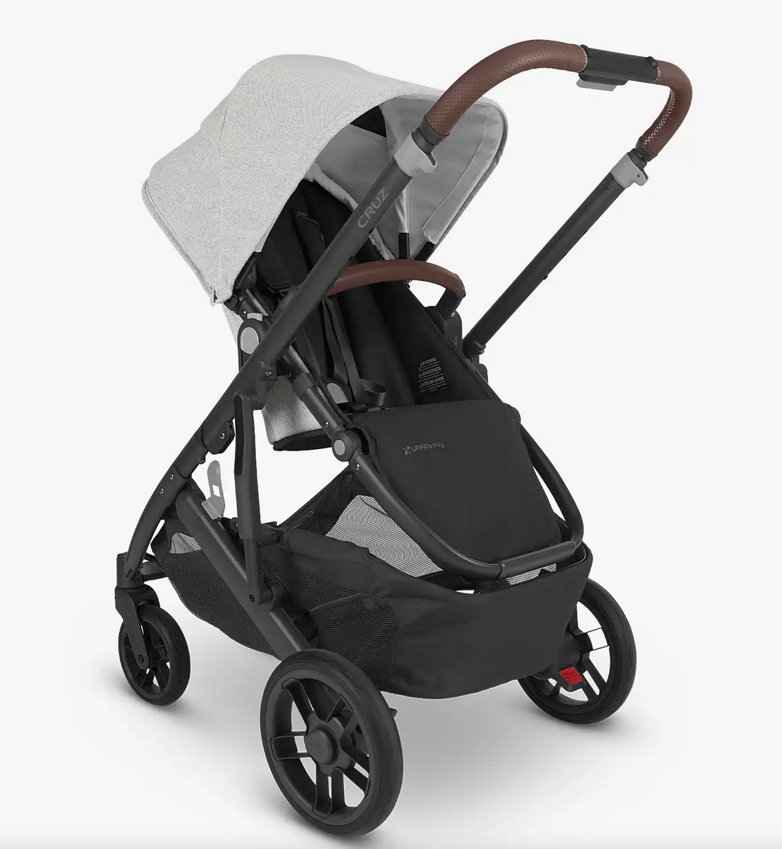 The UPPAbaby Cruz V2 Stroller by UPPAbaby comes in black and gray with a white canopy, brown handle, and an under-seat storage basket. It features four wheels, a reclining toddler seat, and an adjustable handlebar for added convenience.