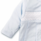 Close-up of a light blue long-sleeve baby dress from Kissy Kissy, made from soft pima cotton and featuring intricate hand smocked detailing on the chest.