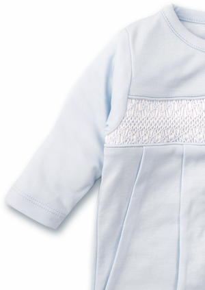 Close-up of a light blue long-sleeve baby dress from Kissy Kissy, made from soft pima cotton and featuring intricate hand smocked detailing on the chest.