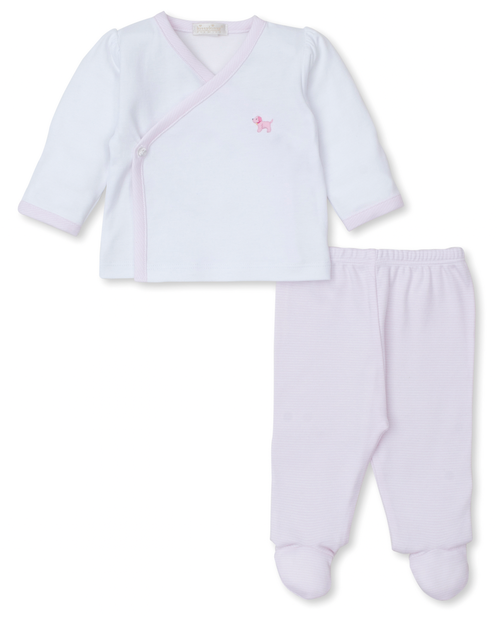 The Kissy Kissy Premier Hand Embroidered Puppies Footed Pant Set by Kissy Kissy includes a white long-sleeve baby top made from soft Pima cotton, adorned with an adorable small dog embroidery, and paired with light pink footed pants. This charming baby outfit offers both comfort and style.