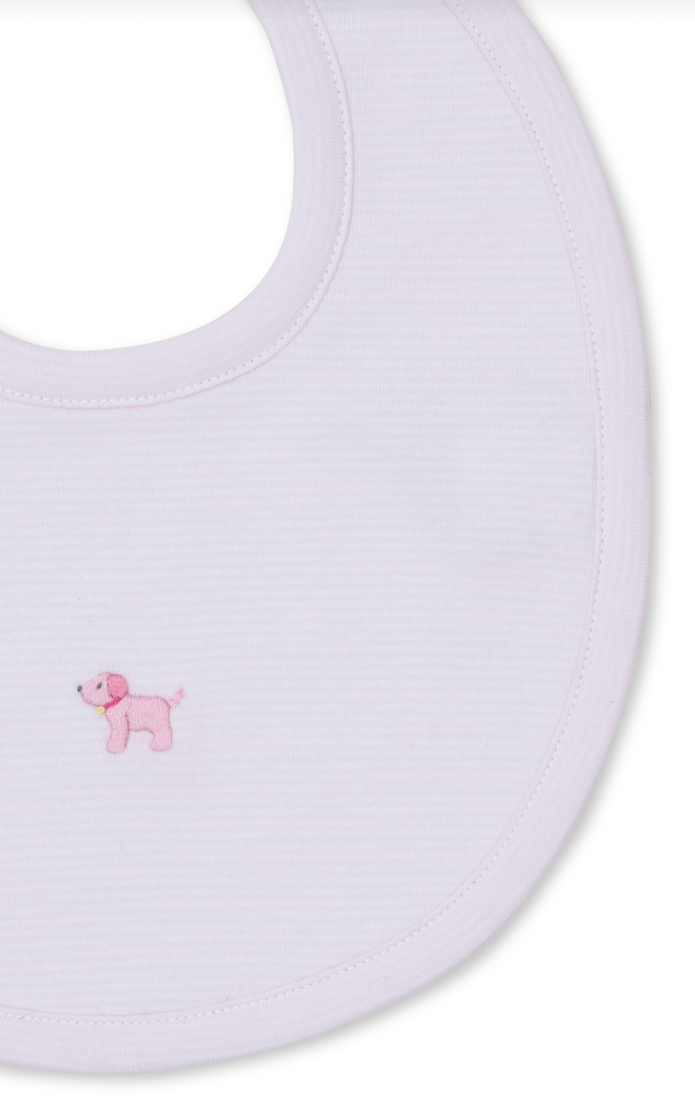 The Kissy Kissy Premier Puppies Hand Emb Bib Pink from the brand Kissy Kissy is a white baby bib crafted from soft Pima cotton, adorned with a small embroidered pink puppy on the front.