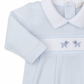 The Kissy Kissy Premier Hand Embroidered Puppies Playsuit by Kissy Kissy features a light blue baby onesie with a white collar and charming blue hand-embroidered dogs on the front. Crafted from soft Pima cotton, this playsuit ensures your little one's comfort and style.