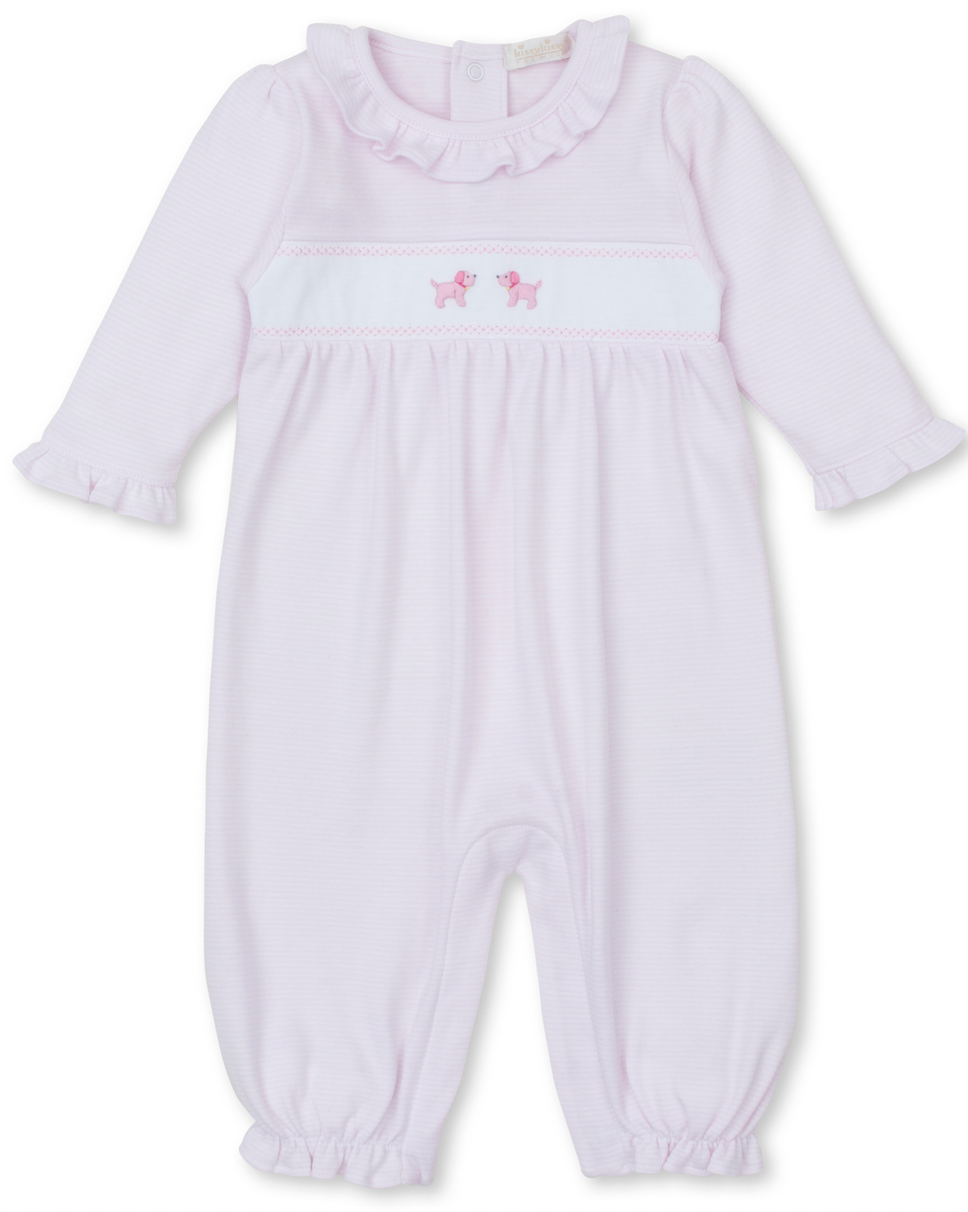 The Kissy Kissy Premier Hand Embroidered Puppies Playsuit by Kissy Kissy is a light pink long-sleeved baby romper made from Pima cotton, featuring a ruffled collar and cuffs with hand-embroidered pink poodles on the chest.