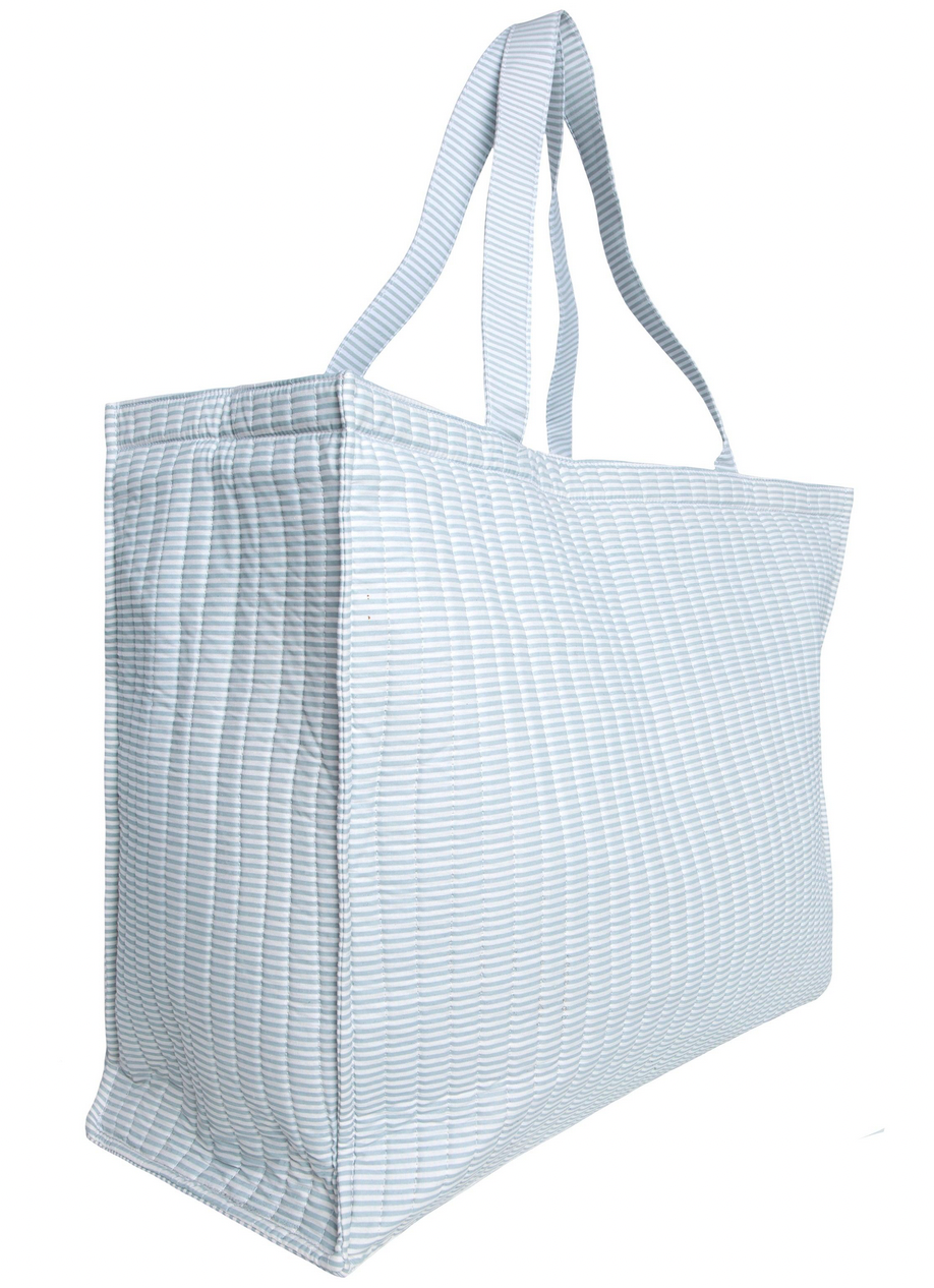 The Minnow Overnighter Tote by Minnow is a large reusable shopping bag featuring a blue and white striped pattern, a spacious interior, quilted fabric, and two handles for easy carrying.