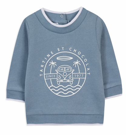 The Tartine et Chocolat Camper Van Sweatshirt is a blue long-sleeve piece featuring "Tartine et Chocolat" text, a graphic of a van, palm trees, waves, and the phrase "Since 1977" printed on the front—perfect for keeping your baby boy cozy this winter.