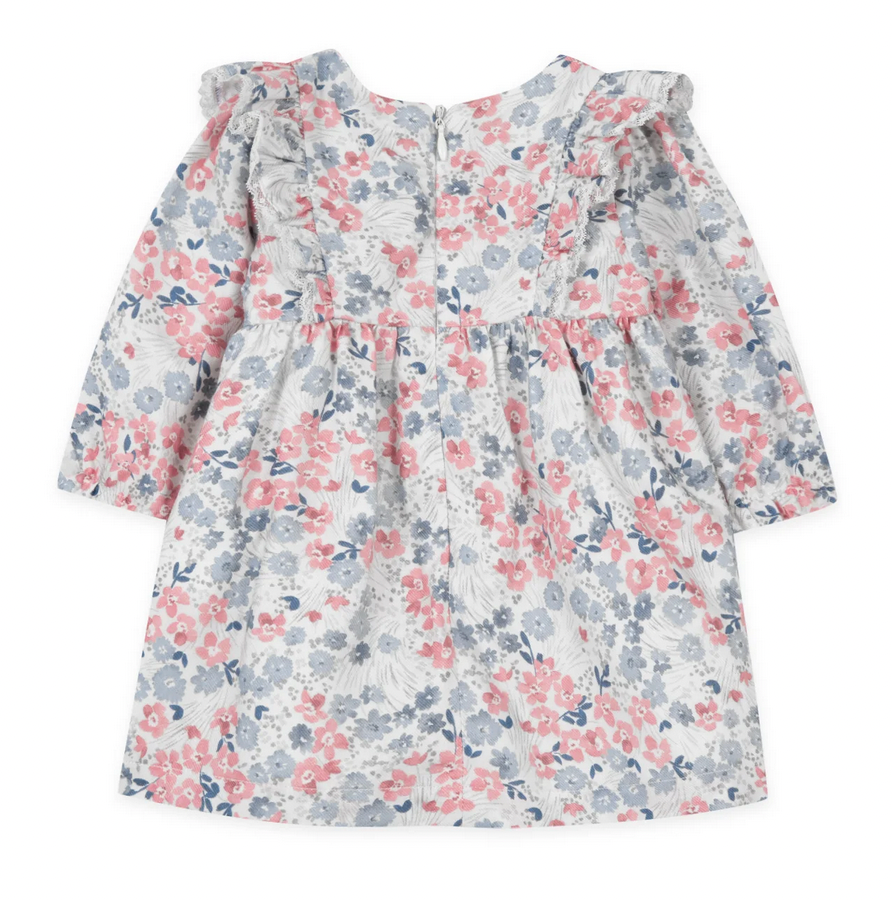 The Tartine et Chocolat Rasberry Printed Flowery Dress by Tartine et Chocolat is perfect for winter outfits. This long-sleeved piece features pink and blue flowers on a white background, ruffled shoulders, and a back zipper closure. Made with quality fabric, it ensures both style and comfort for your baby girl.