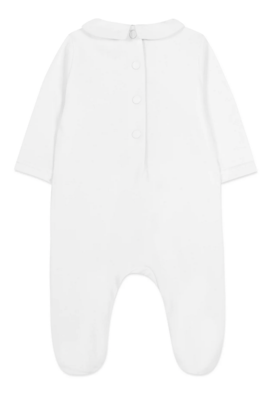 The Tartine et Chocolat Pyjama Snowball Bunny Onesie by Tartine et Chocolat is a plain white baby onesie made from 100% cotton, featuring long sleeves, footed legs, and buttons down the back for easy closure. Perfect for newborns.