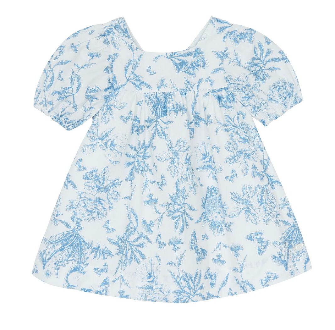 The Tartine et Chocolat Blue Printed Toile Dress, a short-sleeve dress featuring a blue floral pattern on white, is perfect for special occasions.