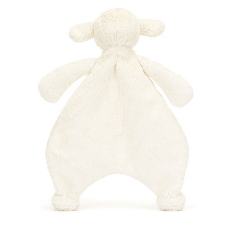 The Jellycat Bashful Lamb Comforter, a stuffed plush toy resembling a lamb, is perfect as a newborn gift. Shown from the back with a soft off-white texture and floppy limbs, this adorable companion is crafted from recycled fibers for an eco-friendly touch.