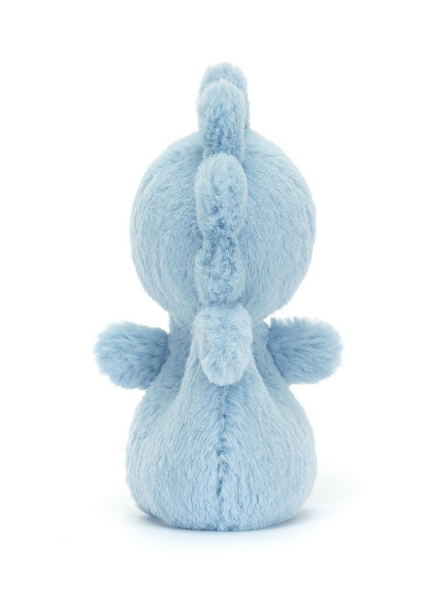 A detailed plush toy with blue, fluffy fabric shaped like a creature standing upright with its back facing the camera is the Jellycat Fluffy Seahorse by Jellycat.