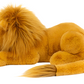 A large, plush Jellycat Louie Lion, Little with honey fur and a silky mane is lying down on its side, flaunting its long tail.