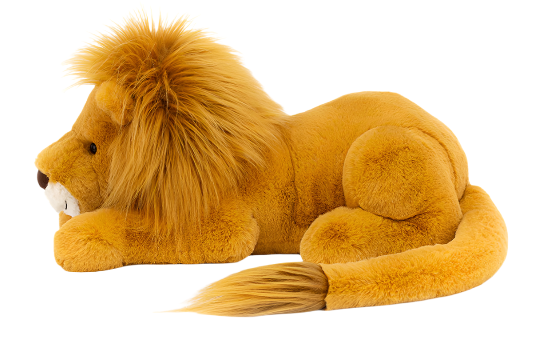 A large, plush Jellycat Louie Lion, Little with honey fur and a silky mane is lying down on its side, flaunting its long tail.