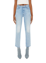 Person wearing light blue Mother Denim The Hustler Ankle Fray jeans with raw hems, light gray pointed-toe boots, and a white cropped top, standing against a plain white background.