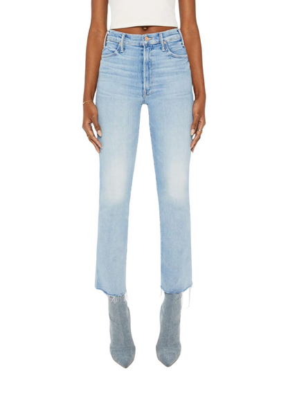 Person wearing light blue Mother Denim The Hustler Ankle Fray jeans with raw hems, light gray pointed-toe boots, and a white cropped top, standing against a plain white background.