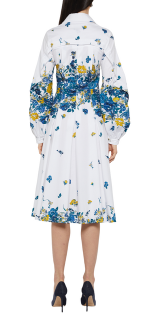 A woman in a Prabal Gurung Long Sleeve Band Collar Shirtdress with blue and yellow patterns, featuring long puffy sleeves and standing in black high heels, shown from the back.