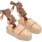 Ulla Johnson Concha Platform Espadrille by Ulla Johnson with woven rope soles and brown ribbon ankle ties. The shoes have a two-tone design, featuring decorative stitching on the upper and a stylish jute platform for added height.