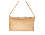 The Bembien Le Traveler by Bembien is a beige, large woven tote bag made from cow leather, featuring tan leather handles and an adjustable shoulder strap. Perfect as a stylish carry-on.