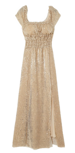 The Altuzarra Lily Dress by Altuzarra is a full-length, off-the-shoulder gown adorned with gold sequins, featuring a gathered waist and a side slit.