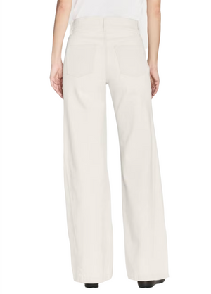 Model wearing Frame Le Baggy Palazzo jeans by Frame, shown from the back. The off-white rigid denim has two rear pockets and extra-loose wide legs, paired with a white top.