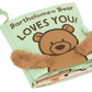 The **Jellycat Bartholomew Bear Loves You Book** by Jellycat features a charming bear illustration and two fuzzy brown bear paws, offering tactile fabrics for little hands to explore.