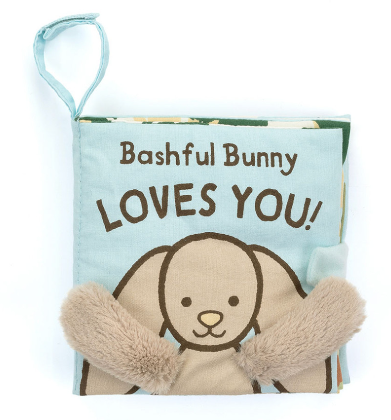 Soft, baby-friendly children's book titled "Jellycat Bashful Bunny Loves You Book" by Jellycat, featuring an illustration of a bunny and plush paw details.