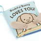 The Jellycat Bashful Bunny Loves You Book by Jellycat is a soft cloth book adorned with an illustration of a bunny with plush ears, making it ideal for baby-friendly reading.