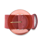 Lizzie Fortunato's Louise Suede Belt in a coral hue showcases an oversized circular buckle made of pink acrylic, complemented by a sleek gold pin fastener.