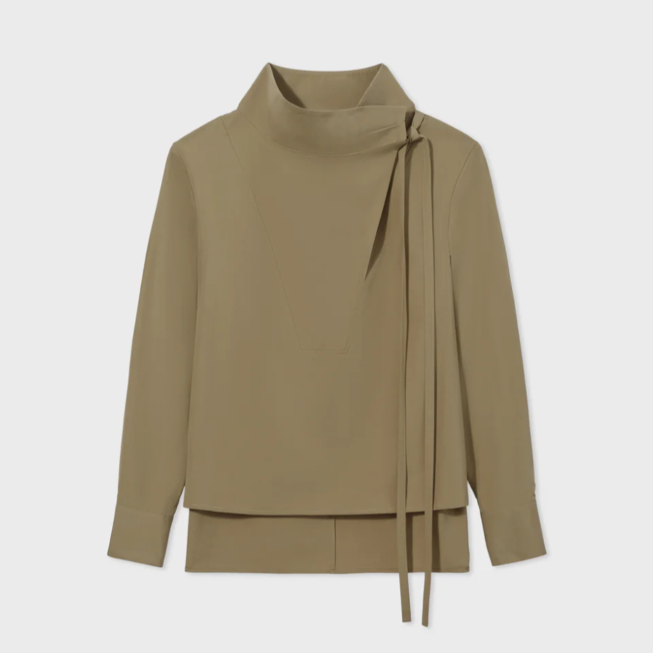 The CO Fencer's Fluid Blouse by CO is a taupe long-sleeve shirt with a cowl neck, high draped collar, and side tie detail.