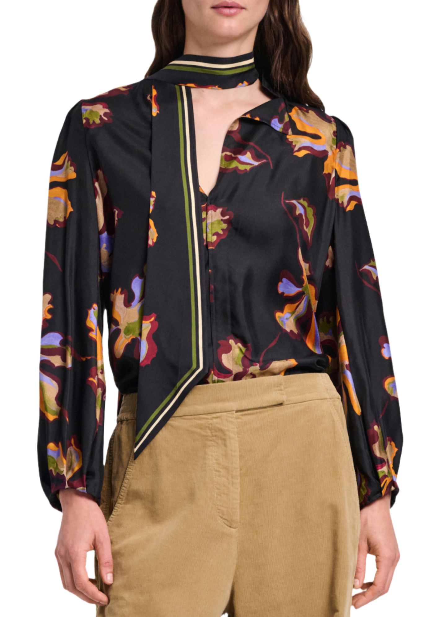 A person wearing the Dorothee Schumacher Floral Seductive Blouse, a black silk top with a flower print and a matching neck scarf, paired with light brown pants.