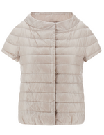 The Herno Emilia Cape is a beige short-sleeve puffer jacket with goose down padding and an ultralight nylon finish, featuring a simple quilted design and a collarless neckline inspired by the signature Herno style.