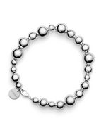 The LIÉ STUDIO Elly Bracelet by Lie Studio is a silver-plated brass accessory featuring an array of spherical beads in different sizes, along with a small, round charm located near the clasp.