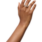 A hand wearing the LIÉ STUDIO The Isabel Ring by Lie Studio, featuring interlocking rectangular elements crafted from sterling silver-plated metal, is shown extending upward against a plain white background.