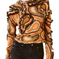 A person wears a long-sleeve Ulla Johnson Sunara Pullover with an intricate multicolored paisley pattern, crafted from soft Italian cotton, paired with black pants.