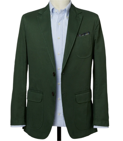 A Sid Mashburn Butcher Jacket, made from Italian canvas in a dark green hue, drapes elegantly over a light blue striped shirt on a mannequin.