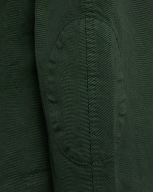 Close-up view of the Sid Mashburn Butcher Jacket in green, featuring a stitched elbow patch crafted from Italian canvas, highlighting its fine texture and seams.