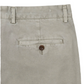 The close-up highlights the back pocket of the Sid Masburn Garment Dyed Field Pant, crafted from lightweight cotton twill. These slim-straight trousers feature a single brown button and belt loops. The beige pants from Sid Mashburn have been garment-dyed for a unique finish.