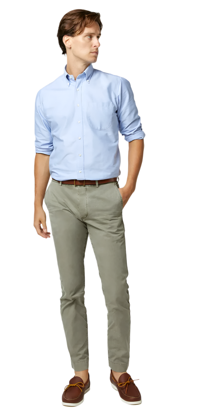 A person in a light blue shirt, Sid Mashburn Garment Dyed Field Pant, brown belt, and brown shoes stands with one hand in their pocket, looking to the side.