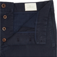 Close-up of the Sid Mashburn Garment Dyed Field Pant, slim-straight navy blue trousers made from lightweight cotton twill, featuring a button fly with brown buttons and labeled "Sid Mashburn.