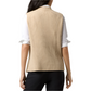 Back view of a woman wearing the Ann Mashburn Sleeveless Funnel-Neck Sweater in beige over a white long-sleeve shirt and dark pants.