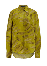 The Brandon Maxwell Spence Shirt showcases a relaxed-fit, long-sleeve design in a yellow-green hue with leaf-like patterns. Crafted from luxurious silk crepe, it features a buttoned front and pointed collar for an effortlessly stylish appearance.