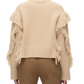 Back view of a person wearing the 3.1 Phillip Lim LS Crewneck W Fringe Trim in beige, paired with brown pants, standing against a plain background.