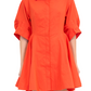 A person wearing the Simkhai Jazzie Mini Dress, characterized by its poplin fabric, vibrant orange color, collared neckline, short sleeves, and flared skirt design.